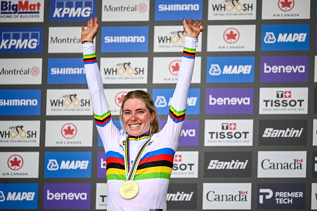 Demi Vollering with her arms aloft wearing the rainbow jersey as women's elite road race winner at the World Championships 2026