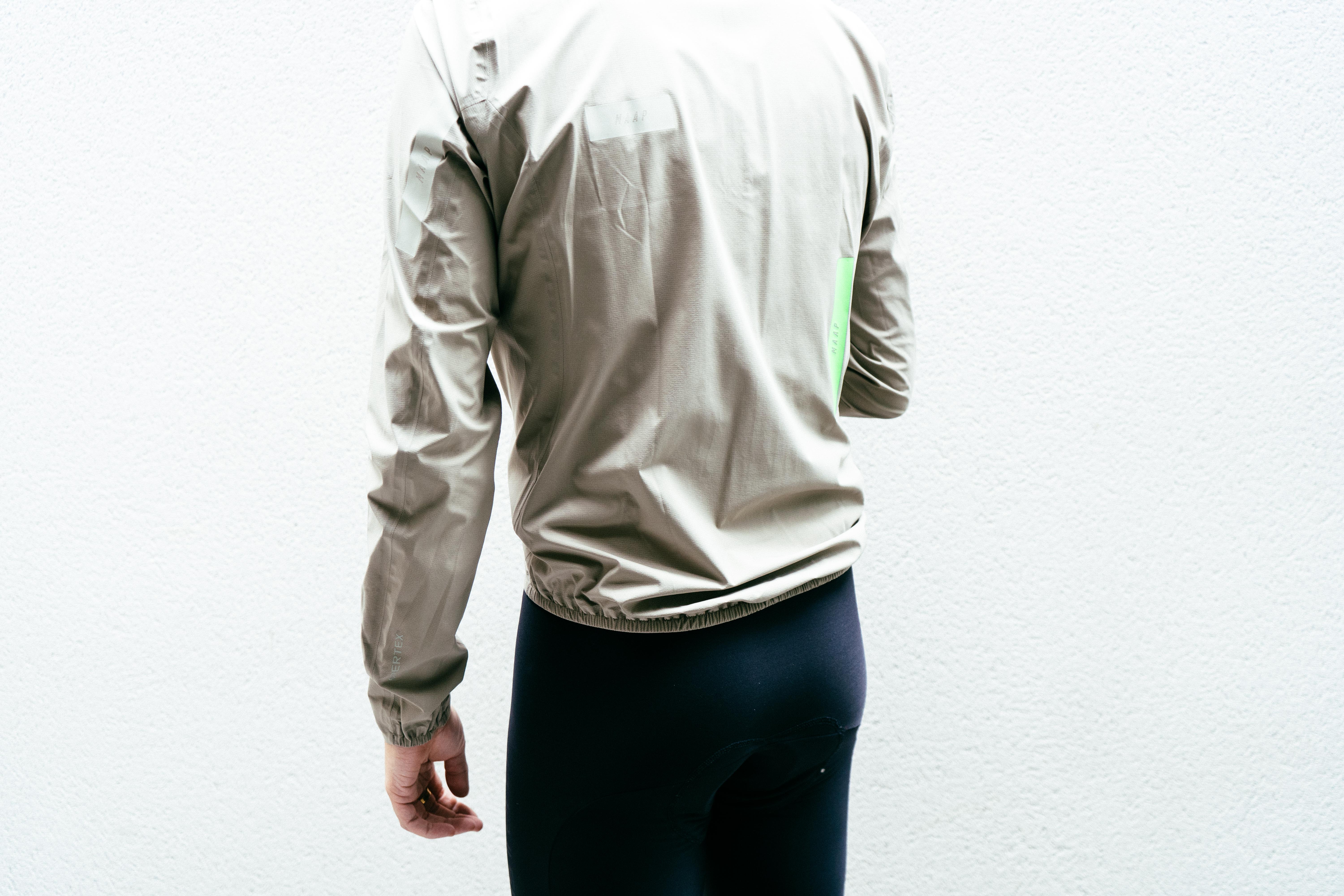 The lower hem of an off-white waterproof cycling jacket