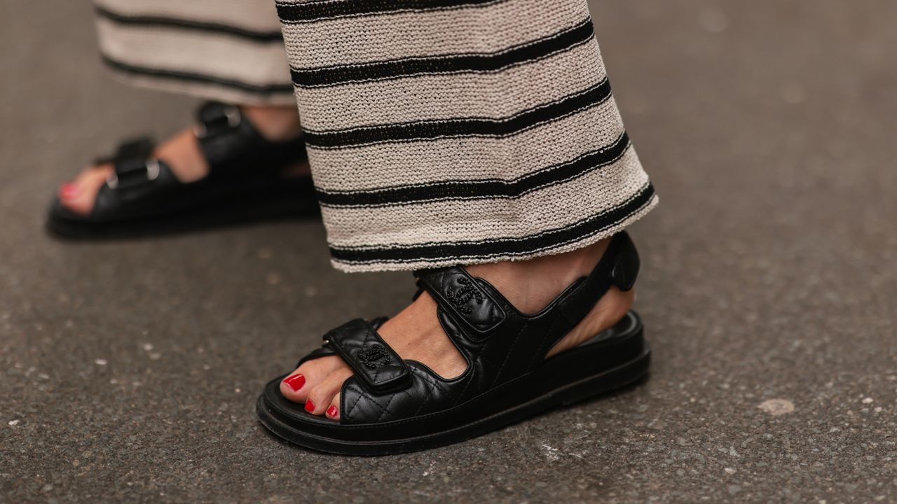 Close up of woman&#039;s feet wearing Chanel sandals