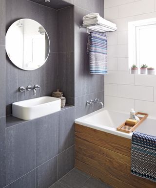 bathroom with black and white tile and bath tub