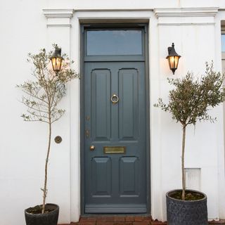 Exterior of house with white walls and black door