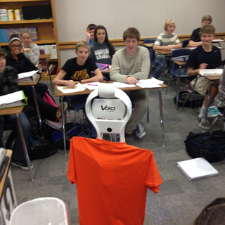 Derek Hall's VGo robot with a shirt on it in a Texas classroom.