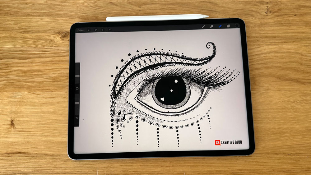 An iPad Pro on a desk with a picture of an eye on the screen