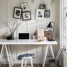 home office with panelled white wall and table lamp