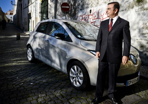 Chairman and CEO of France-based Renault, Carlos Ghosn, stands with one of the company&amp;#039;s electric cars in 2013.