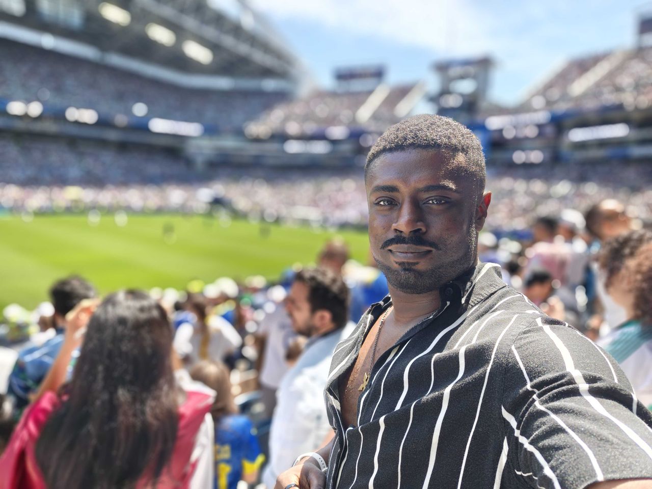 Taking a selfie in the stands with the field behind me