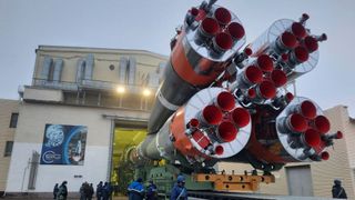 A view of a Soyuz-2.1b rocket, meant to carry OneWeb satellites into orbit, being load into a hanger at Baikonur Cosmodrome