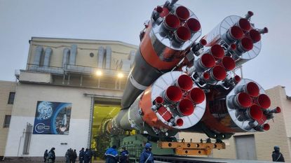 A view of a Soyuz-2.1b rocket, meant to carry OneWeb satellites into orbit, being load into a hanger at Baikonur Cosmodrome