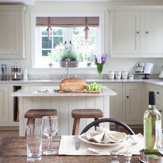 kitchen with bread and grapes on white counter