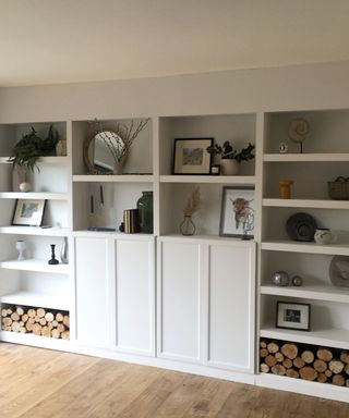 IKEA BILLY bookcase hack in a living room with white paint and stylish accessories, including books, vases and photo frames