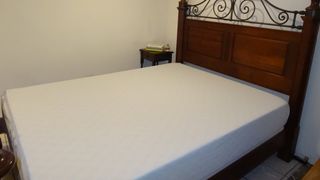 Zinus Green Tea Memory Foam mattress on a wooden bed frame