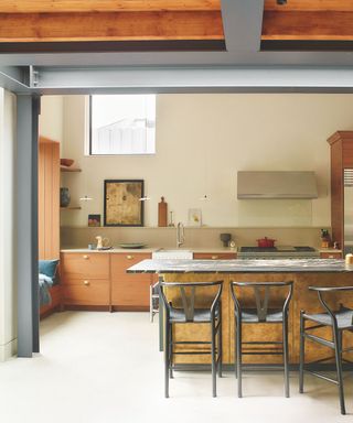 modern kitchen with neutral colors and wood and gold cabinetry and marble top