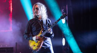 Mikael Åkerfeldt wears corspepaint as he plays his PRS Custom 24 onstage with Opeth