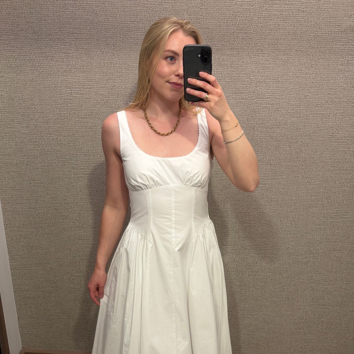 Woman wears white dress from Abercrombie