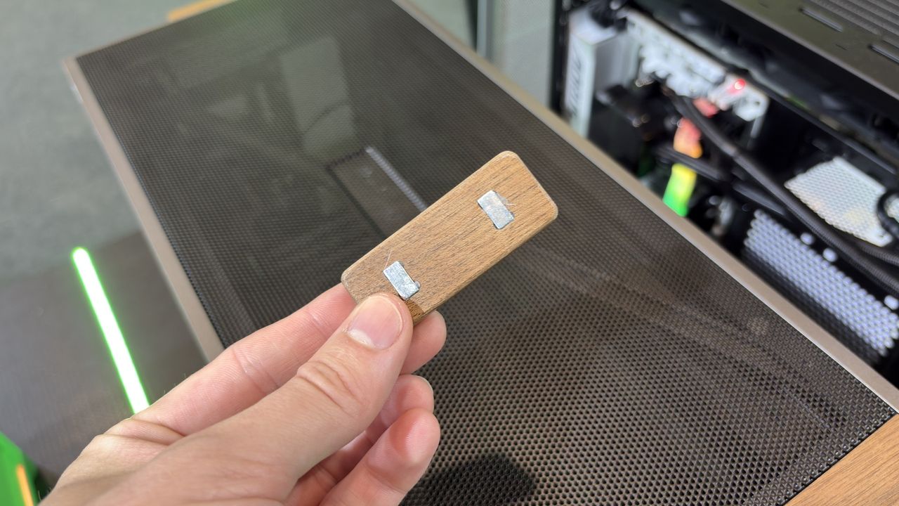 Montech Ten Wood case diffuser block, in a hand