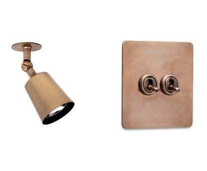 The Perryn Single Spotlight (left) and the Two Way Toggle Switch (right), both in Antique Brass, from Corston&rsquo;s extensive architectural lighting range.