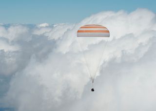 Soyuz TMA-19M Space Capsule Under Parachutes