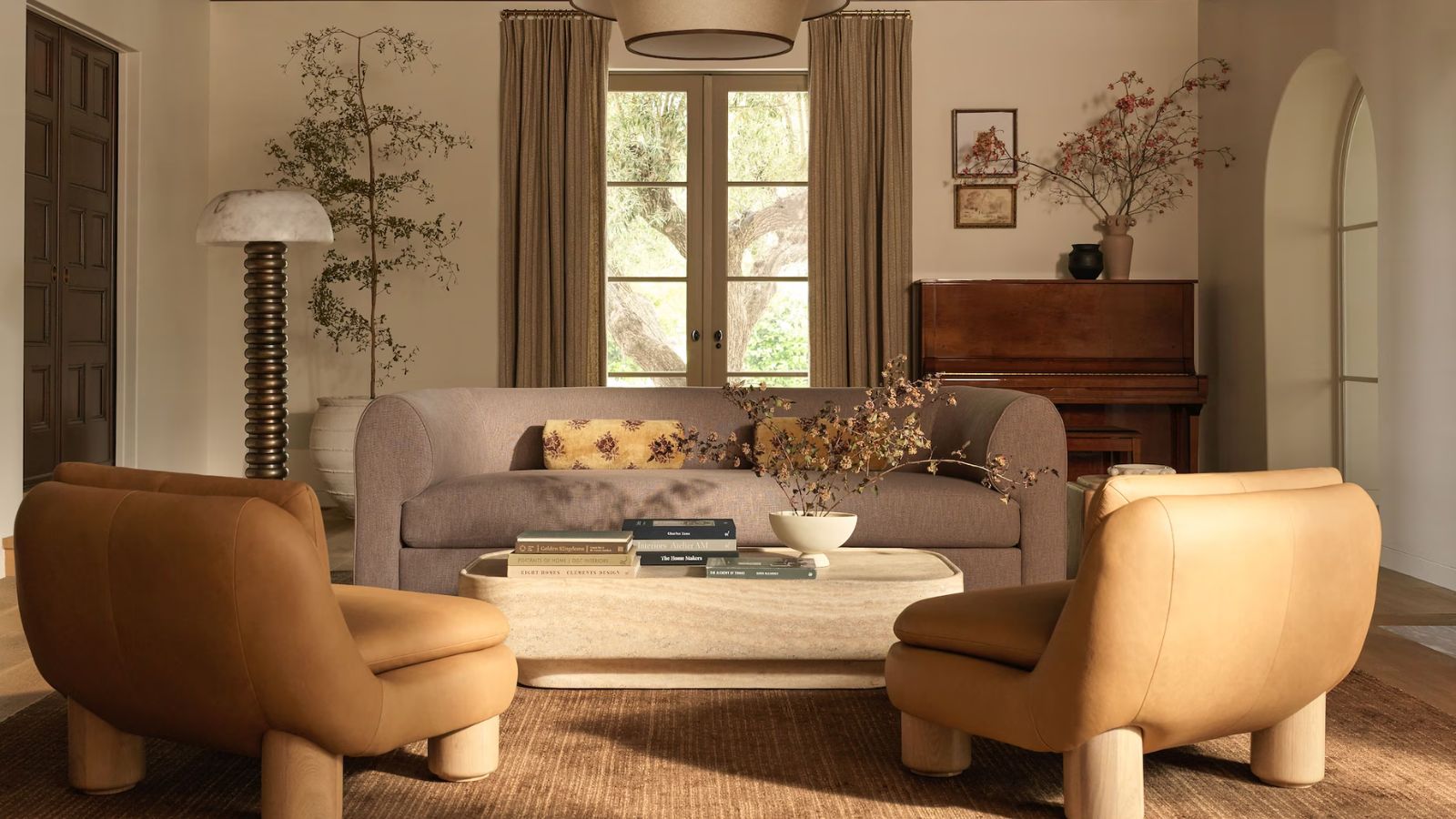 lulu and georgia fall collection living room wit velvet couch and two leather armless chairs