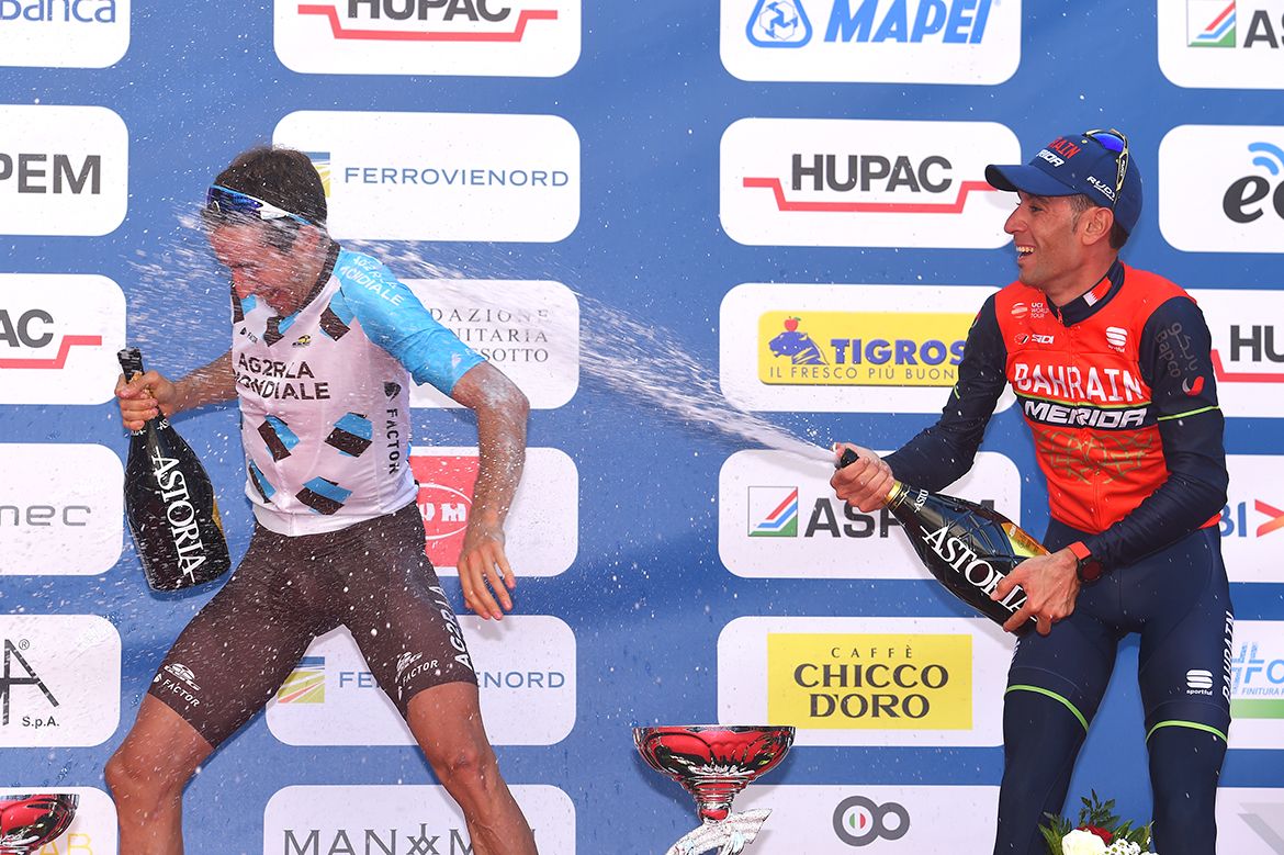 Vincenzo Nibali gives Alexandre Geniez a celebratory dousing in champagne