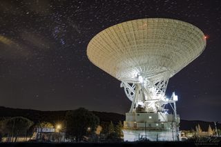 A long-exposure shot shows star trails above DSS-63 at the Madrid Deep Space Communications Complex.