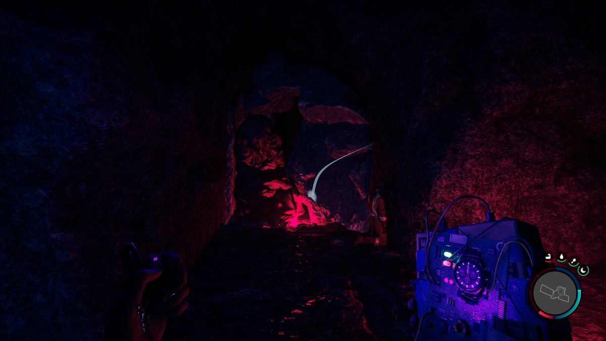Sons of the Forest - a player holds a time bomb and aims at a large slimey monster wedged inside a crevice.