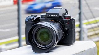 Panasonic Lumix G9 II camera on a wall by the side of a motor-racing track