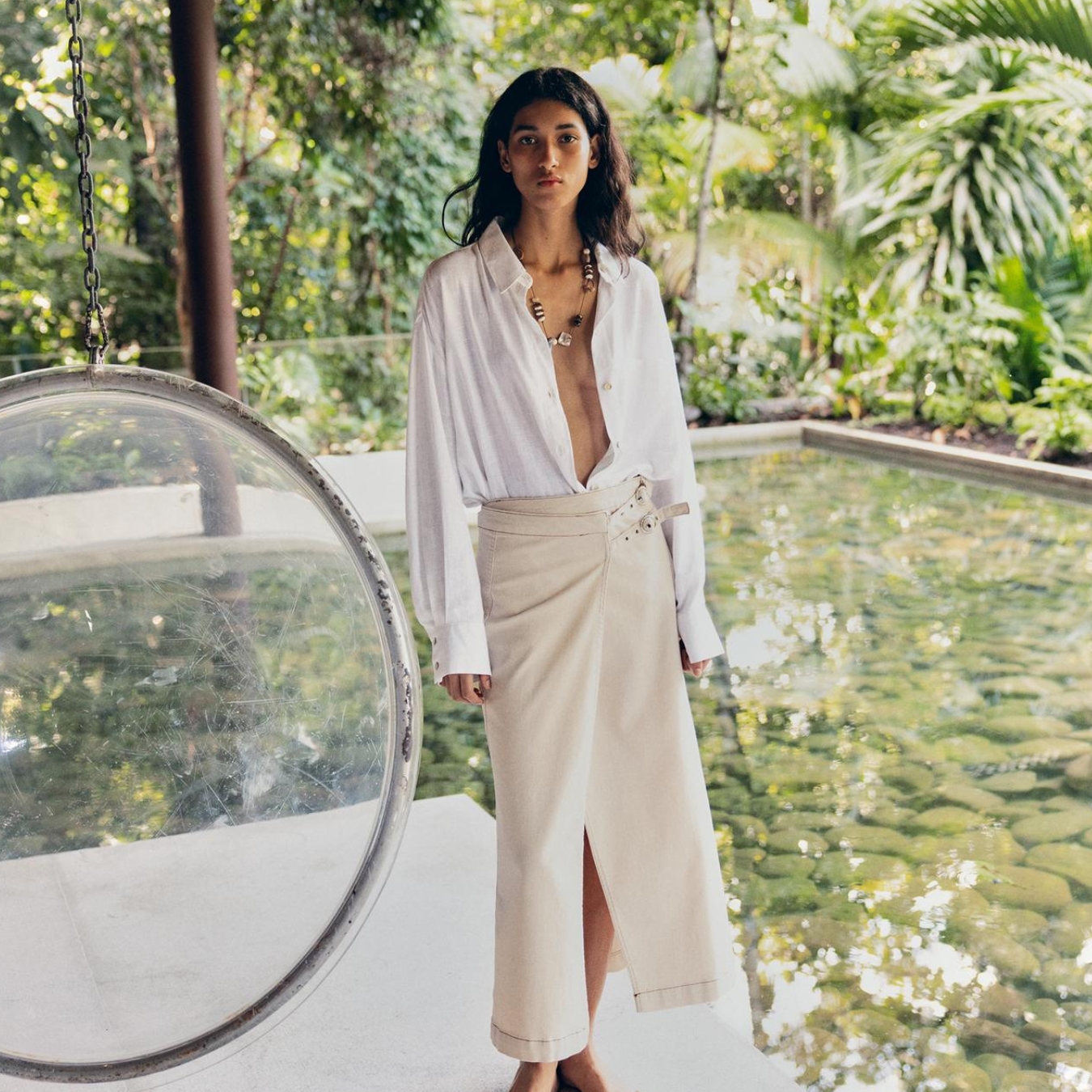 Model wearing white shirt and skirt from Zara.