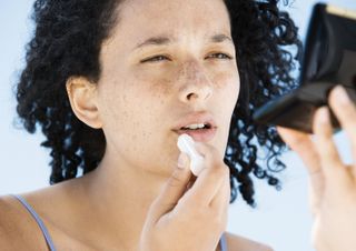 Woman using chapstick