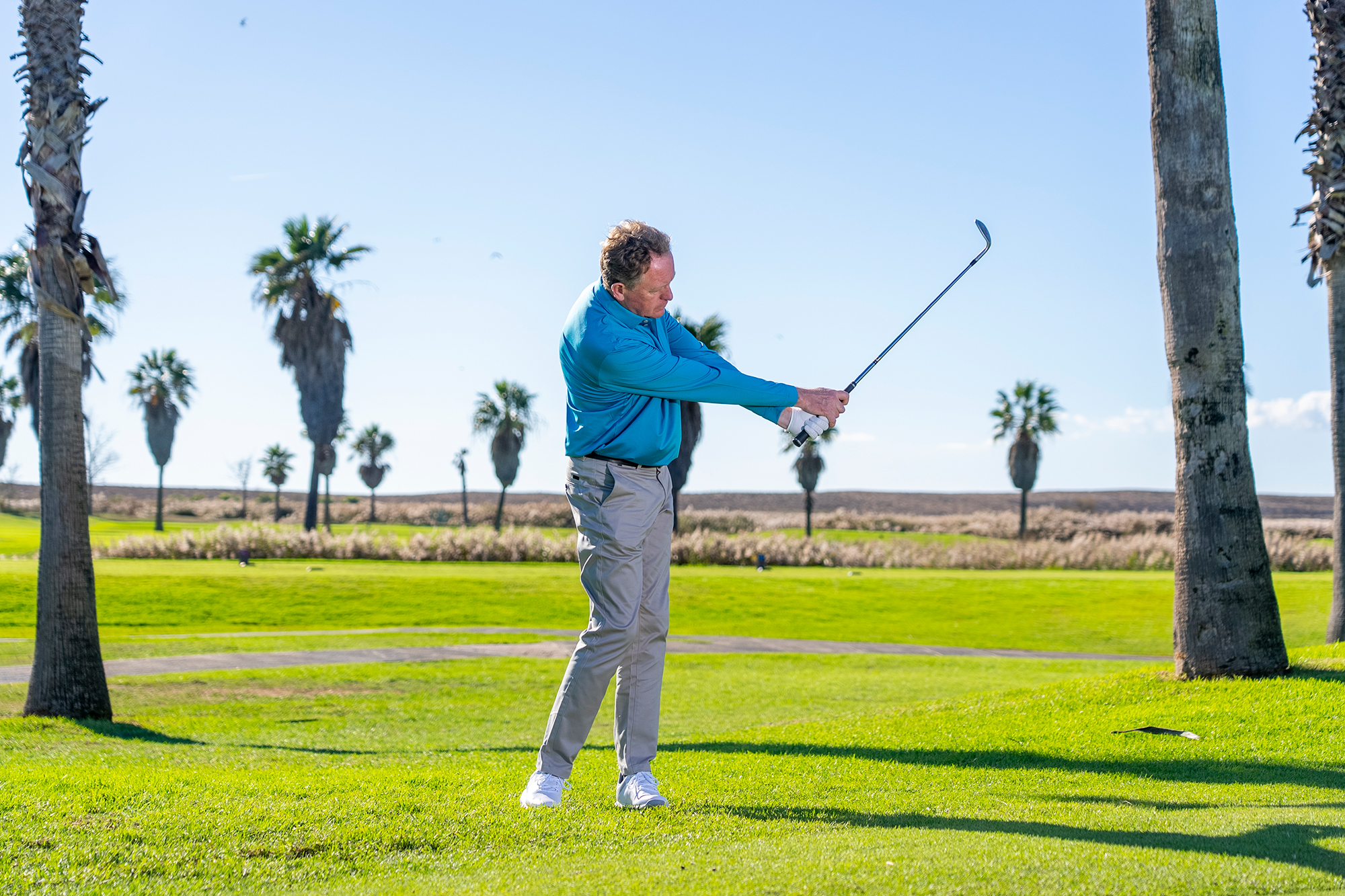 Keith Wood in the follow through position with a wedge, with his arm at just below shoulder height