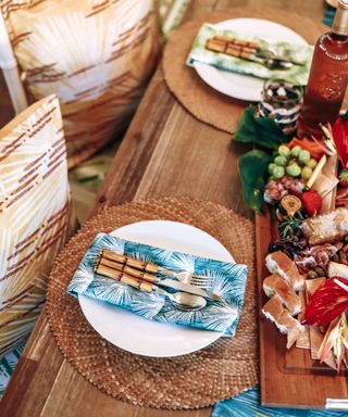 An outdoor tablescape with a tropical theme