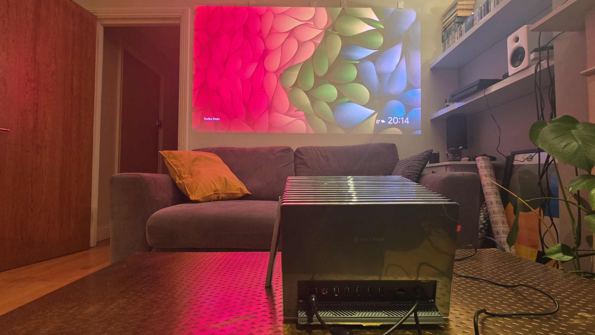 The Valerion VisionMaster 2 Pro on a table, projecting its screensaver against a wall.