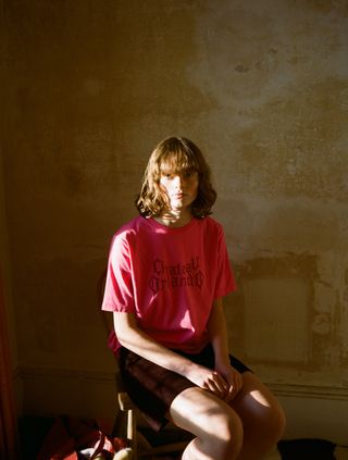 Boy in Chateau Orlando T-shirt sat in sun-lit house