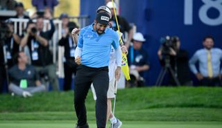 Matthieu Pavon fist pumps after holing the winning putt on the 18th hole