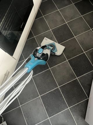 Using a steam cleaner to clean a vinyl floor