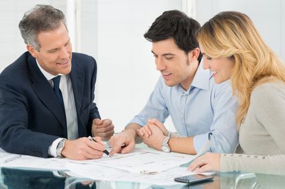 Happy Couple Looking Blueprint About New House