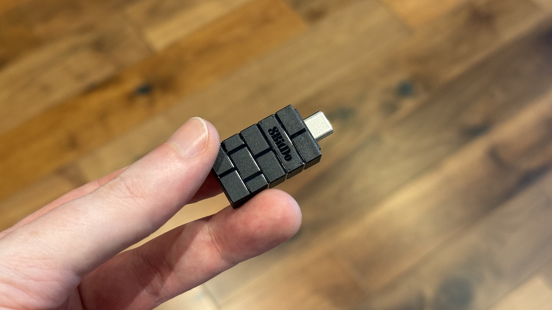 The 8BitDo Ultimate 2 controller, with dock and USB connection at home
