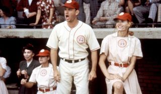 A League of Their Own Tom Hanks yells from the dugout as Geena Davis smiles