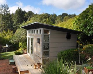 modern shed by studio shed in backyard