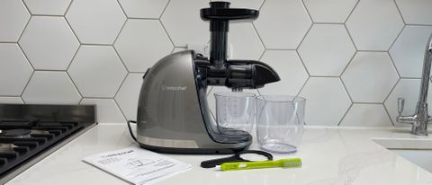 The Amzchef Slow Juicer ZM1501 with its accessories on a kitchen countertop