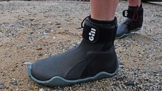 Person's feet wearing Gill Marine Edge Boots