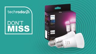 Two Philips Hue lightbulbs with box on blue background with white text reading &#039;TechRadar Don&#039;t Miss&#039;