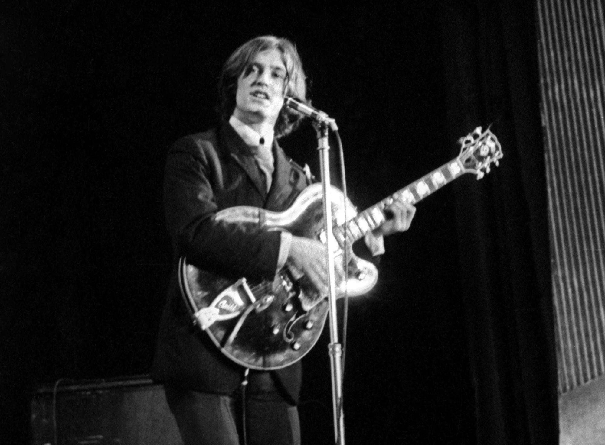 Dave Davies performs onstage with the Kinks at the Olympia Hall in Paris in 1964