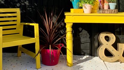 painted patio floor with yellow table