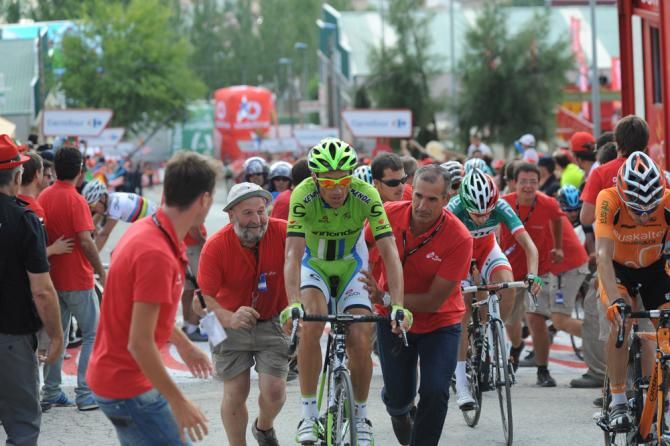 Ivan Basso (Cannondale) is helped over the line
