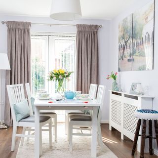 dinning room with white wall and window