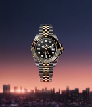 Rolex Oyster Perpetual GMT-Master II watch against cityscape backdrop