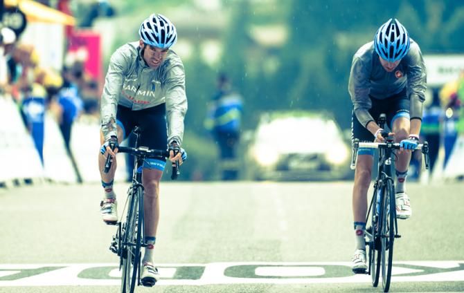 The rain starts to fall on the finish line in La Grand Bornand as Ryder Hesjedal and David Millar arrive at the finish.