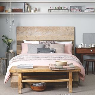 light grey bedroom with distressed wood headboard