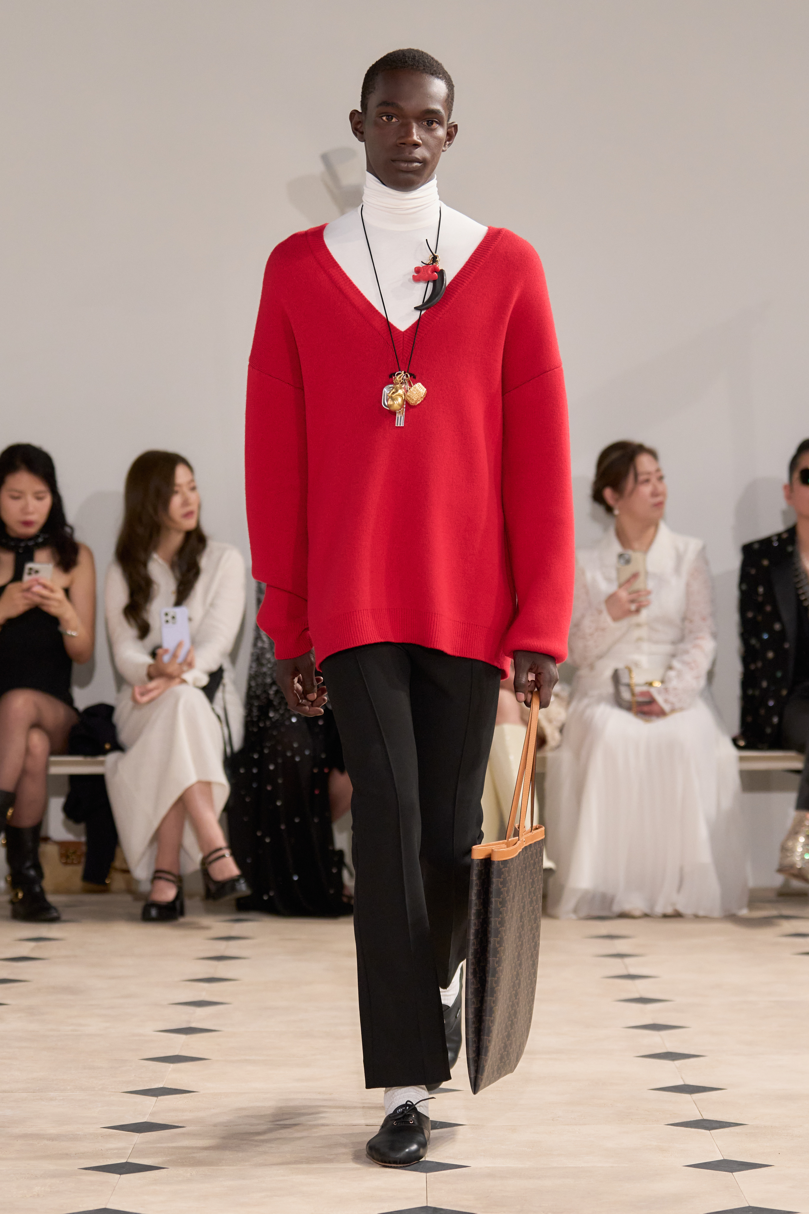 a model wears a celine sweater with an oversize red sweater