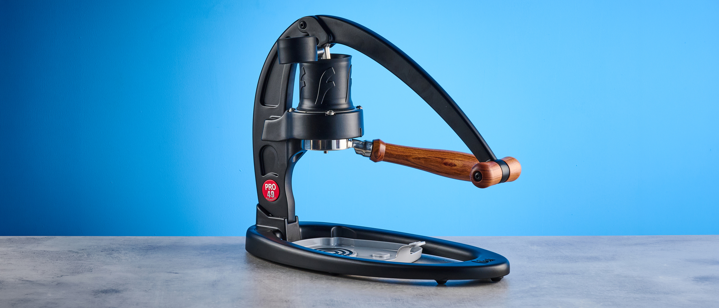 the flair 49 pro lever espresso machine photographed against the blue tom's guide background